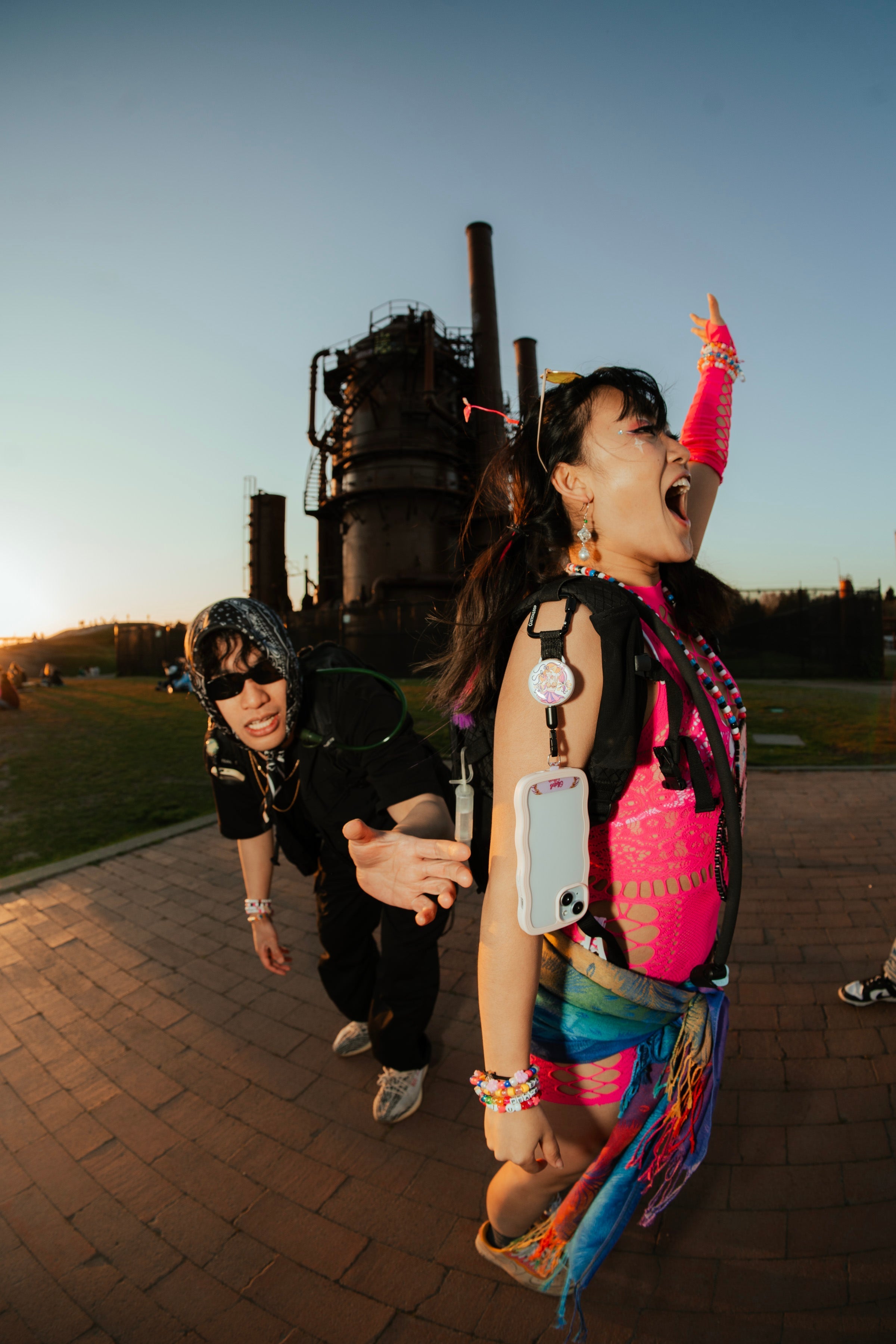 Thief attempting to steal a phone from a festival-goer, prevented by ClutchLoop anti-theft phone tether