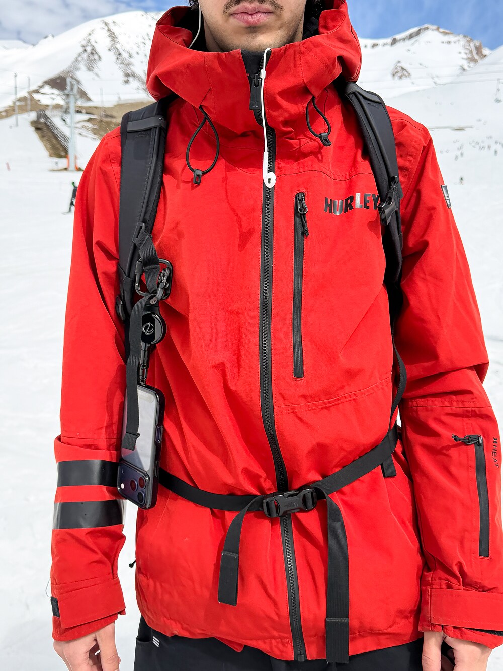 Midnight ClutchLoop on a backpack over a red snow jacket
